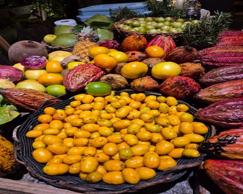 A vibrant basket filled with lulo, maracuya, and various other local fruits